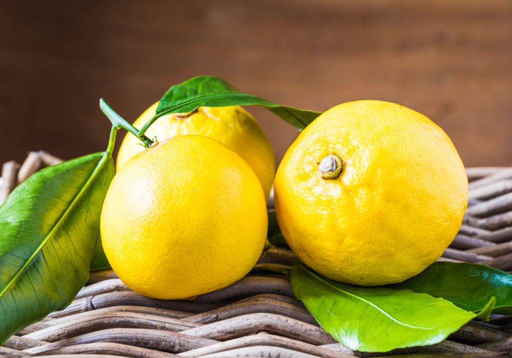 Fresh Calabrian bergamot fruit on a wooden surface